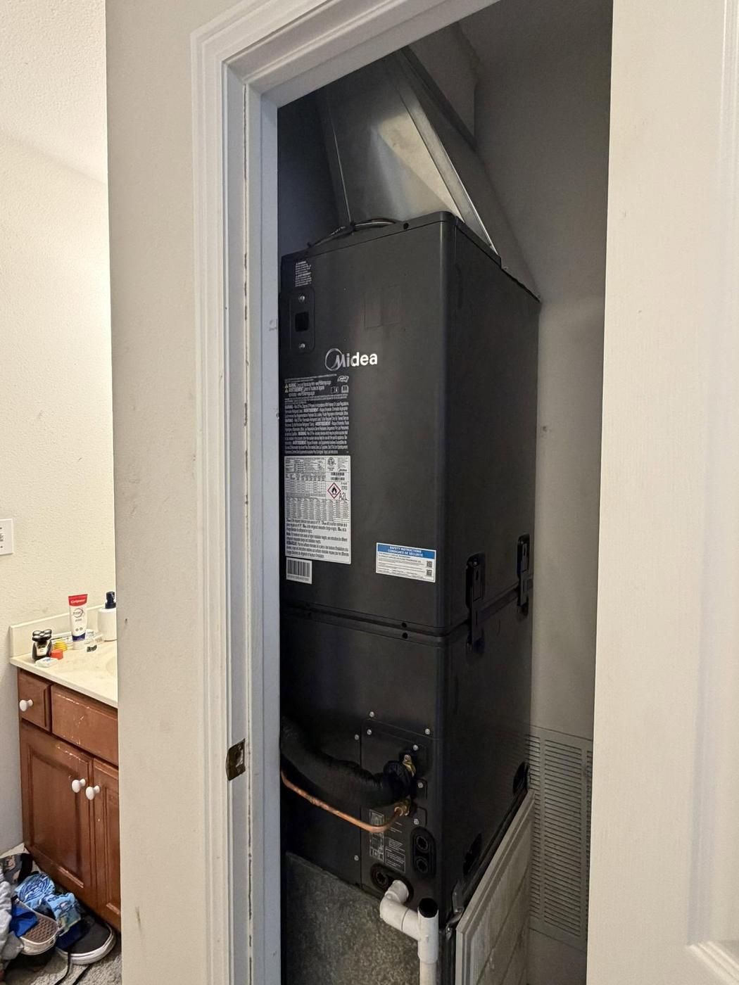 Midea air handler installed in a hallway closet