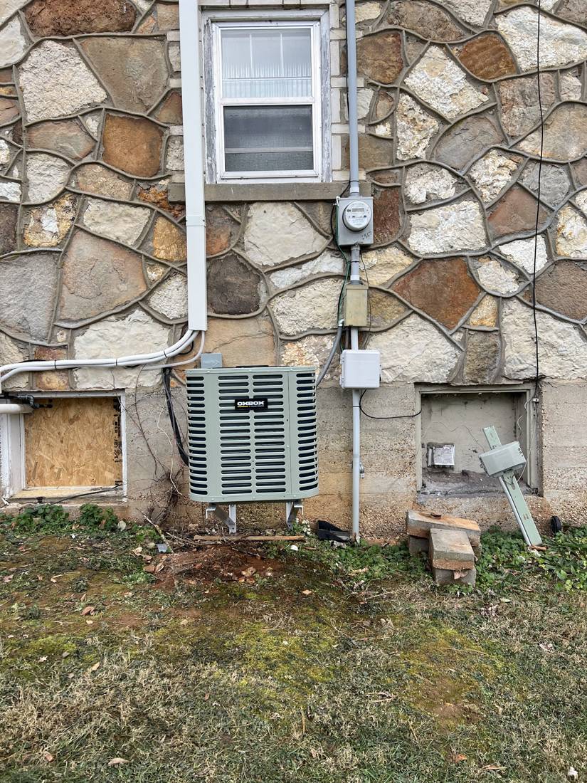 Oxbox condenser installed on a pad below a window
